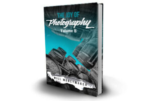 The Joy of Photography, Volume 6 book cover featuring a view between buildings toward a blue sky.