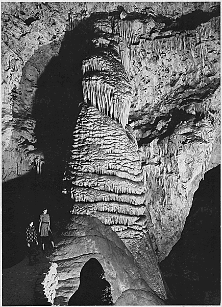 "Rock Formation with Women, Dark Background, 'The Rock of Ages, Big Room,' Carlsbad Caverns National Park," New Mexico (Vertical Orientation)