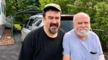 Last photograph of Will Moneymaker and his dad together, standing in a driveway beside a white SUV.