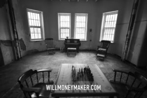 One photographic subject: a black-and-white room with a piano, rocking chairs, and a chess table.