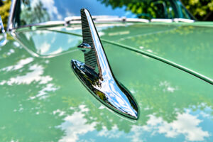 Chrome hood ornament on a vintage green car photographed during a short photography outing
