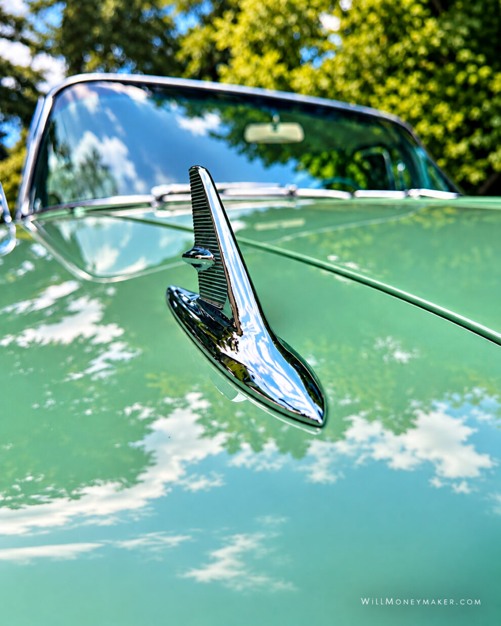 Chrome hood ornament on a vintage green car photographed during a short photography outing